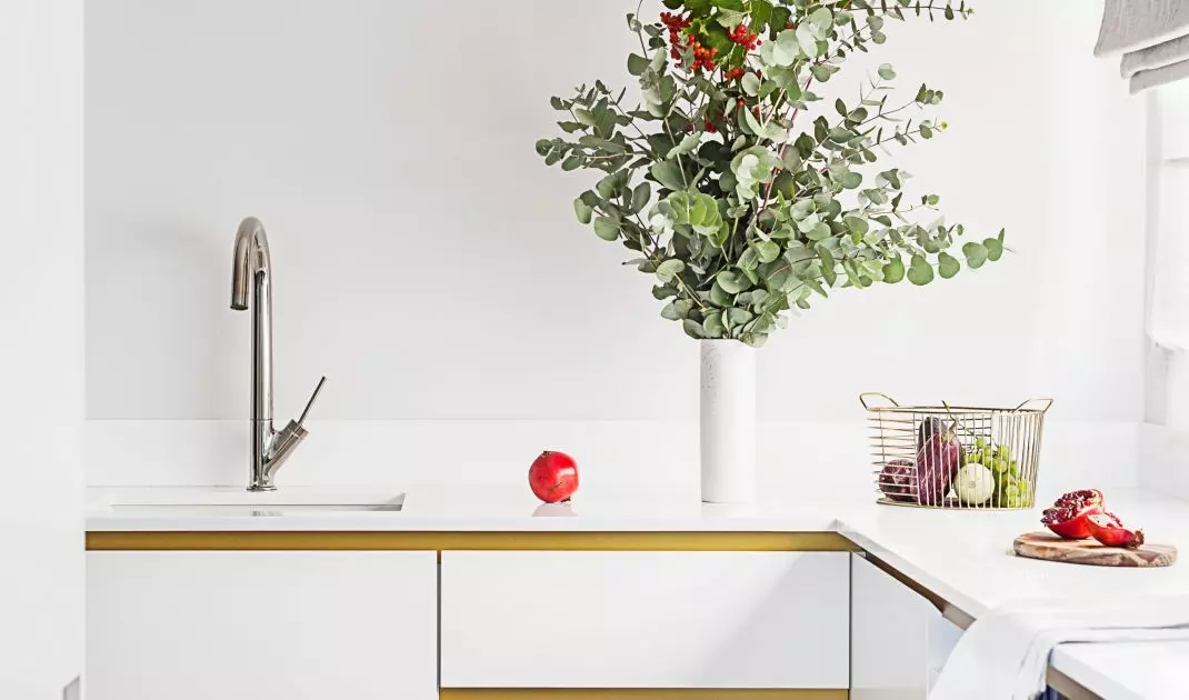 The white kitchen cabinets were complemented with gold details