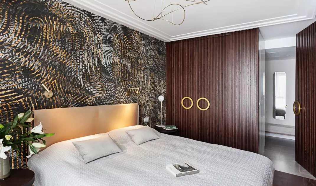 In the design of the bedroom, gold is interspersed with dark colors