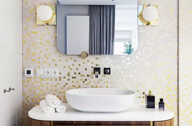 The bathroom is decorated with a golden mosaic