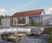 Terracotta-colored solar roof fits in with suburban or urban development