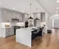 Kitchen island and countertop including facing made of quartz conglomerate LuminaStone by Cava