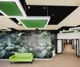 Colorful acoustic Silencer H islands in the communal spaces of the Warsaw Senior Citizens' Home enliven the space and form a perfect duo with the lighting surrounding the panels