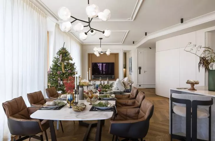 There are brown leather chairs at the large dining table