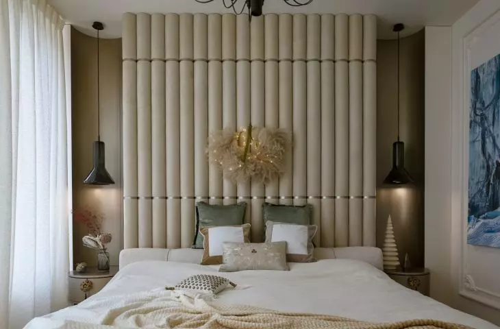 Upholstered headrest covers the full height of the wall