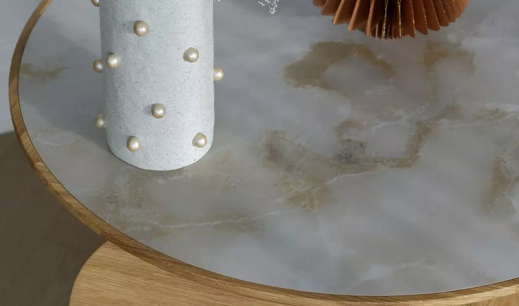 Round table decorated with tiles from the Onice Bianco Mat collection