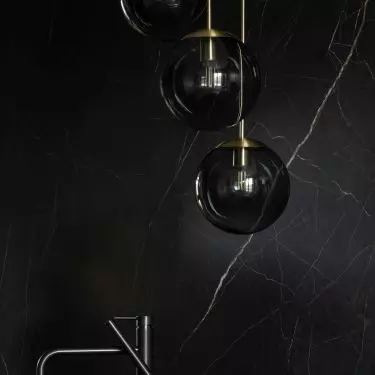 Above the bath in the bedroom hangs a decorative lamp