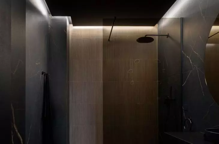 The bathroom is dominated by black