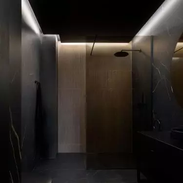 The bathroom is dominated by black