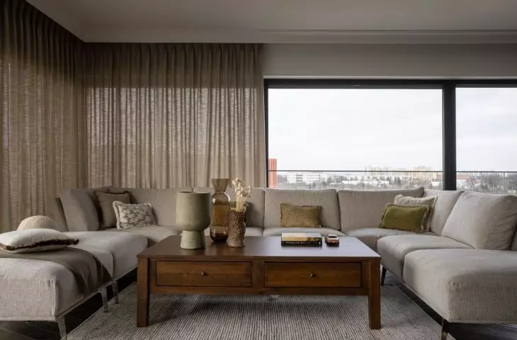 The living room has large glass windows on three sides