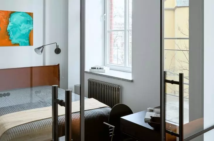 The bedroom is separated from the living room by sliding doors