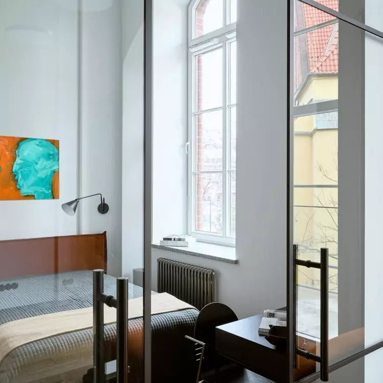 The bedroom is separated from the living room by sliding doors