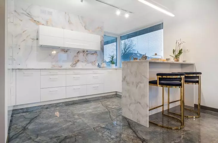 The kitchen design is dominated by white