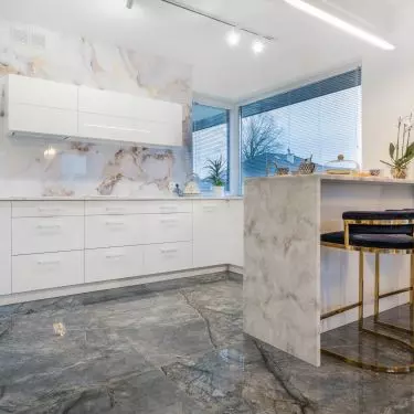 The kitchen design is dominated by white