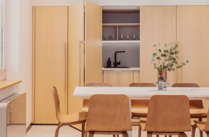 The kitchenette is hidden behind sliding fronts