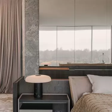 Near the bed stand mushroom-shaped lamps 