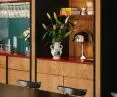 the use of a bookcase instead of a bar catches the eye at Pieno