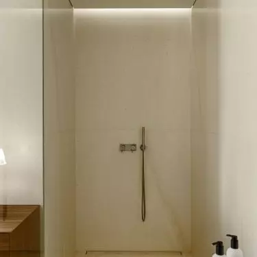 The minimalist shower was separated only by a glass wall
