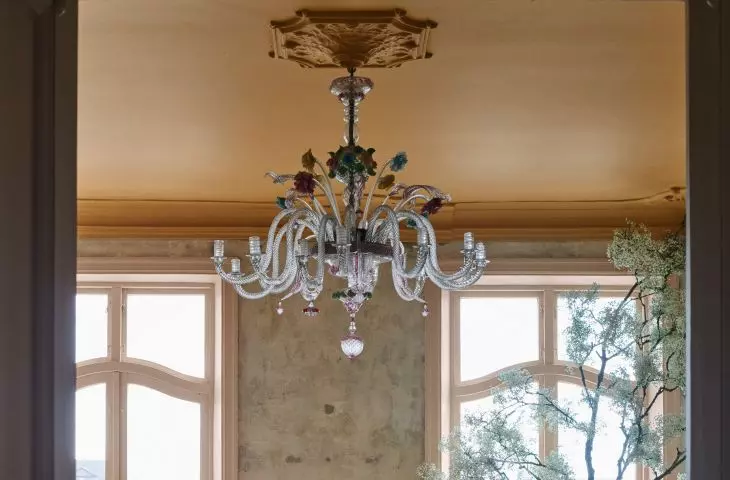 A crystal chandelier and an artistic sculpture create a sublime arrangement