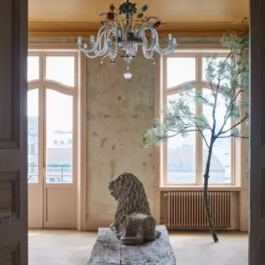 A crystal chandelier and an artistic sculpture create a sublime arrangement