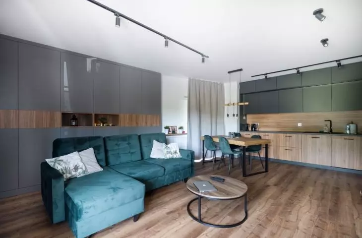 Kitchenette with matte green fronts in the upper development strip