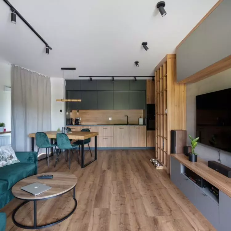 An arrangement combining natural wood, bottle green and raw loft-style accents