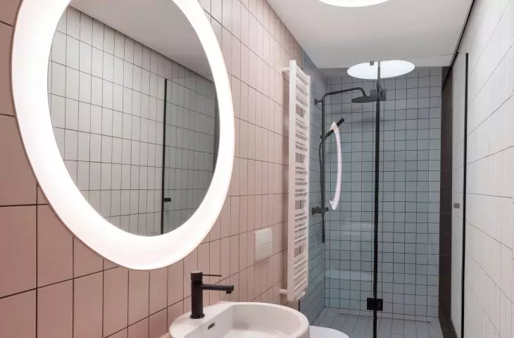 A walk-in shower was placed in the elongated room