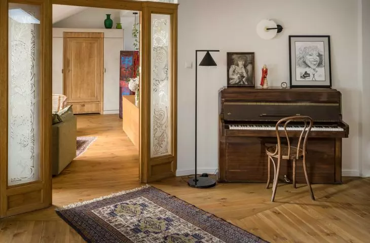 The studio features an antique piano