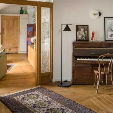 The studio features an antique piano