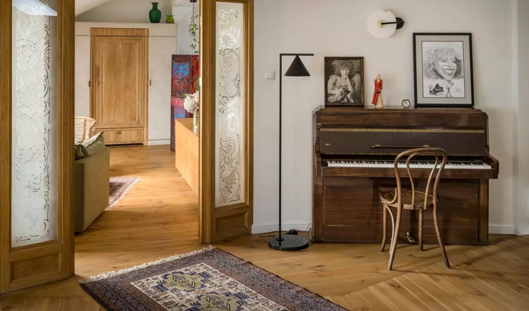 The studio features an antique piano
