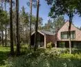 The architects wanted the building's form and facade materials to blend in with the forest surroundings as much as possible