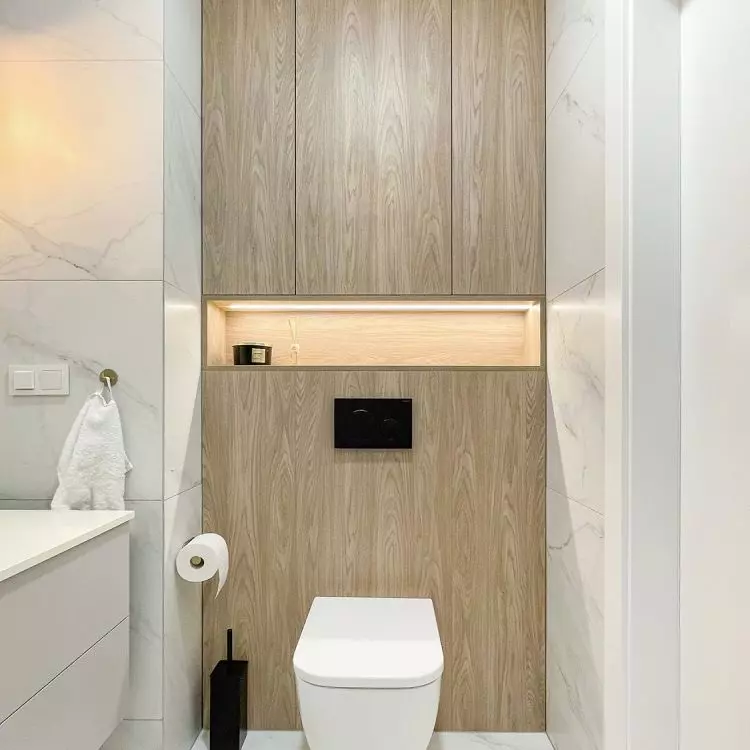 The built-ins above the toilet include an open illuminated shelf