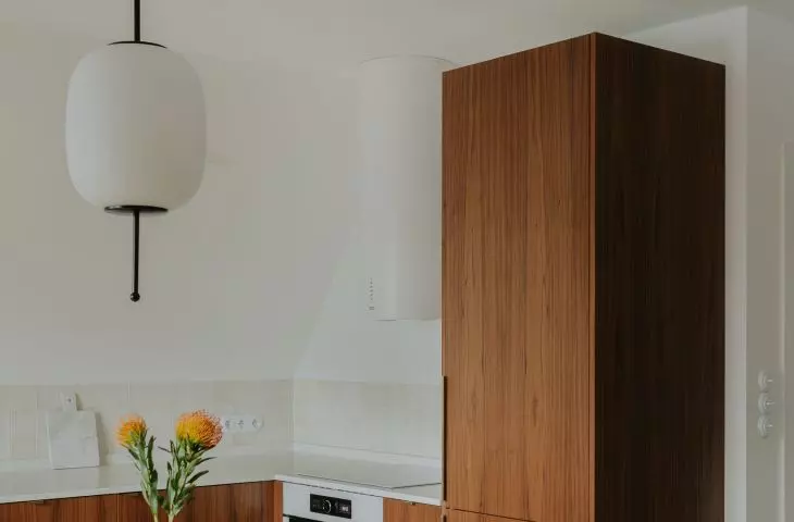 Kitchen cabinetry, and an antique glass vase on the table