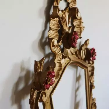A mirror with a decorative frame is a great addition to a Coquette-style interior