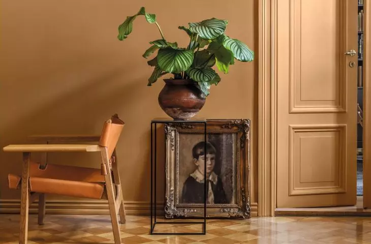 An antique painting in a gold frame is an intriguing decoration