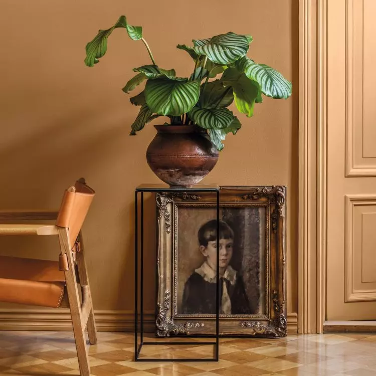 An antique painting in a gold frame is an intriguing decoration