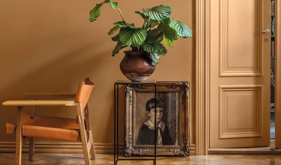 An antique painting in a gold frame is an intriguing decoration