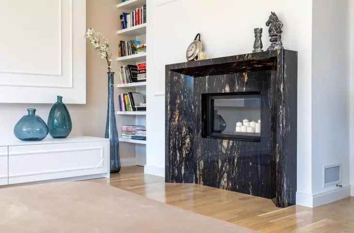 The fireplace surround is made of striking stone