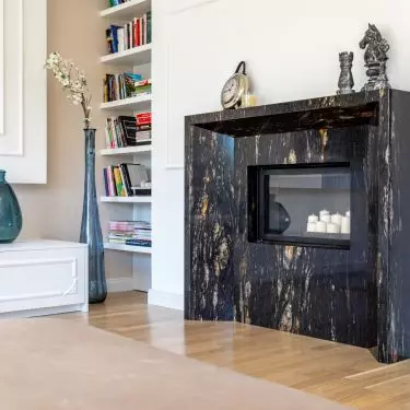 The fireplace surround is made of striking stone