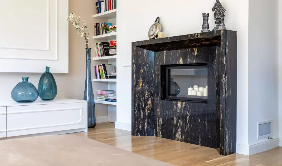 The fireplace surround is made of striking stone