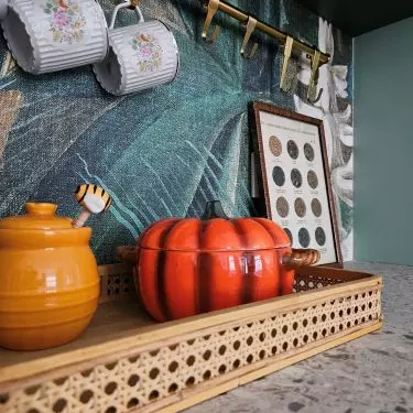 The area above the countertop was decorated with wallpaper with a botanical pattern