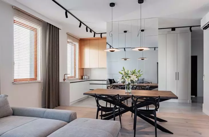 The kitchen has been separated from the living room by a mirrored wall