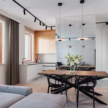 The kitchen has been separated from the living room by a mirrored wall