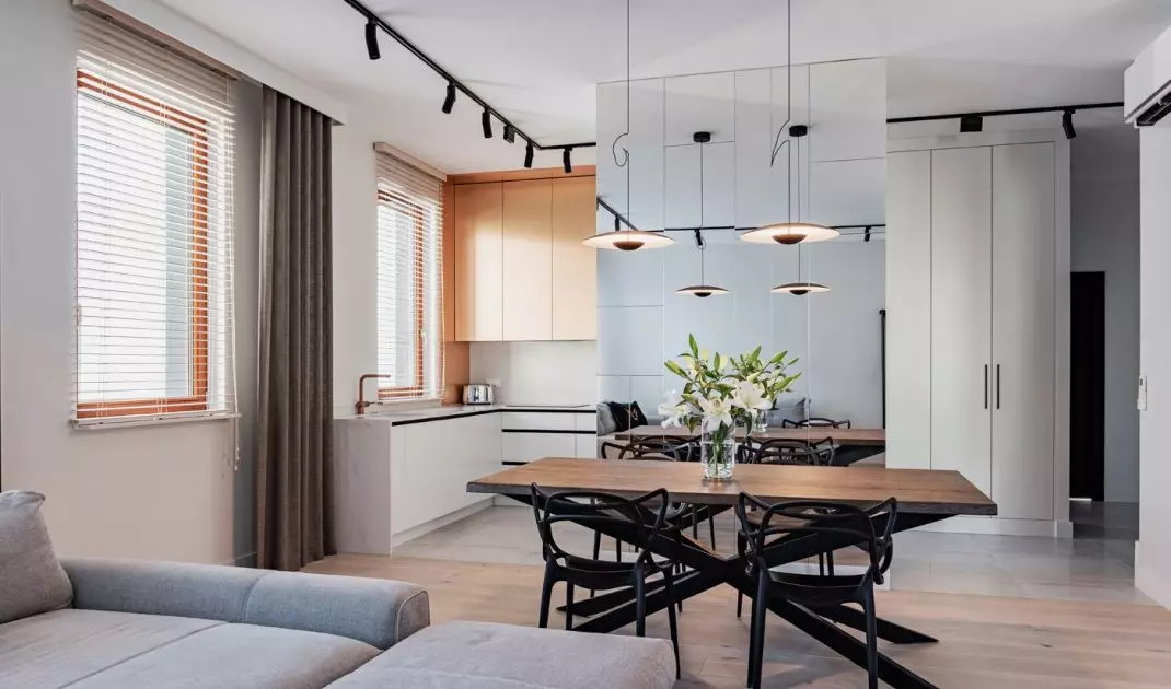 The kitchen has been separated from the living room by a mirrored wall