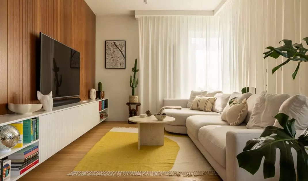 The living area has a wooden TV wall