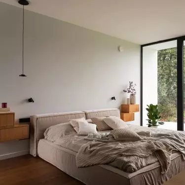 In the lighter part stands a bed