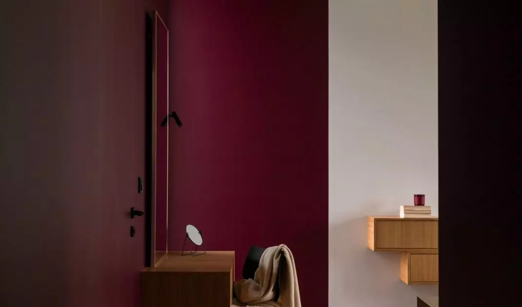 Toilet was placed against a colorful wall