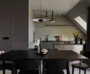 Dining room connected to the kitchen kept in grays
