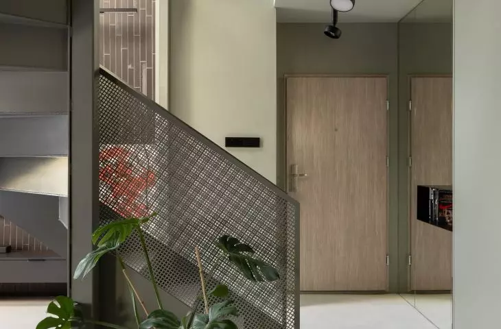 A distinctive staircase leads to the first floor with a bedroom and office