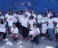 Volunteers, children participating in the painting of Peace Walls and Tsipi Ben-Haim in the background of two New York walls realized by CITYarts