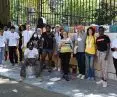 Volunteers, children participating in the painting of Peace Walls and Tsipi Ben-Haim in the background of two New York walls realized by CITYarts